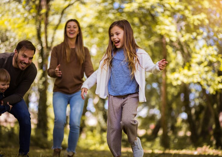 Lachende Familie mit zwei Kindern in der Natur | © © iStock.com/Liderina